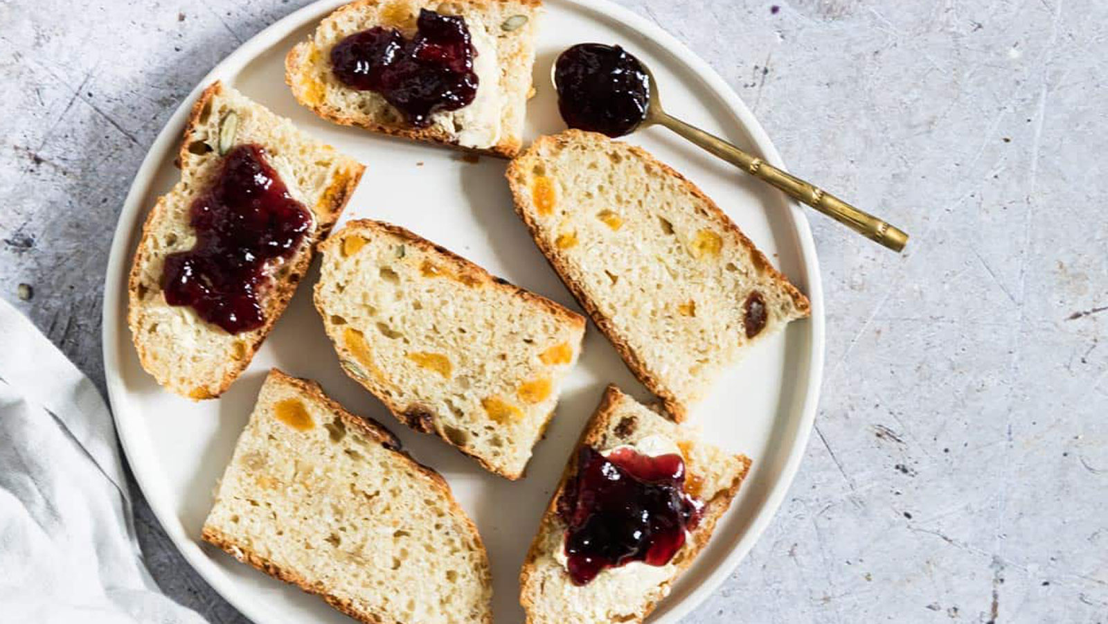 Sliced muesli bread on a white plate.