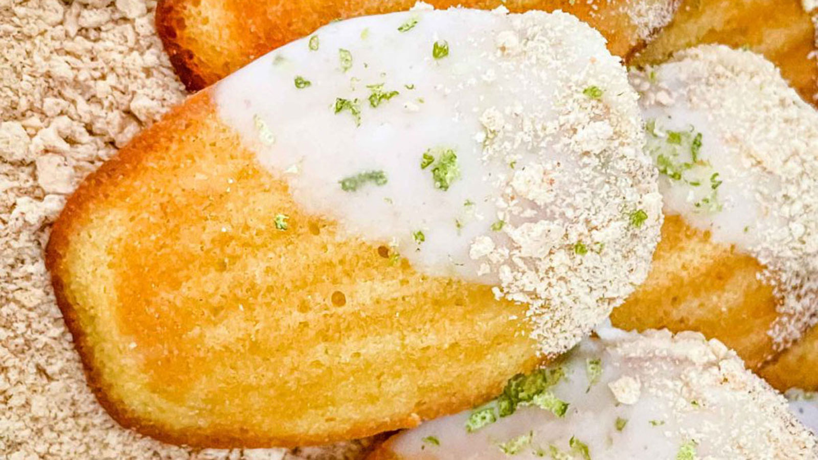 Close up of a lime madeleine with lime frosting.