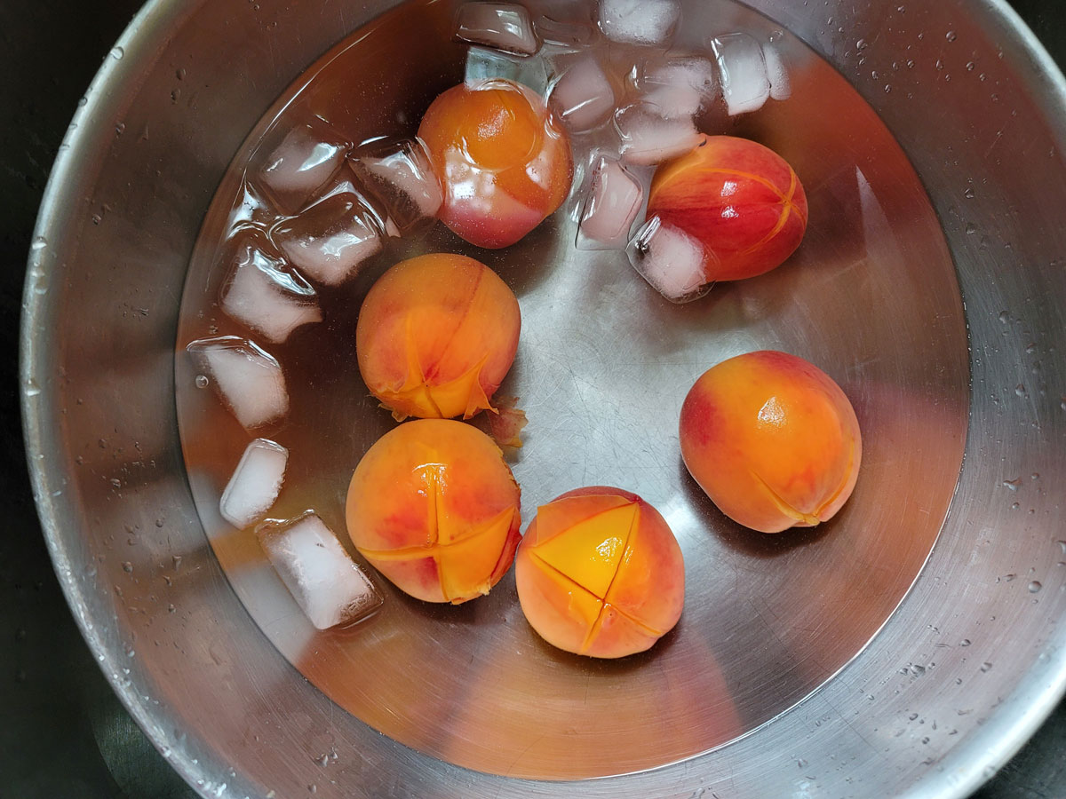 Peaches placed into the ice bath to cool.