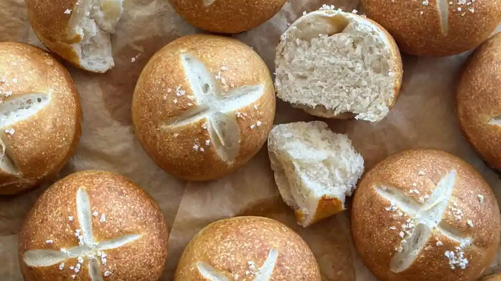 Pretzel buns on parchment paper.