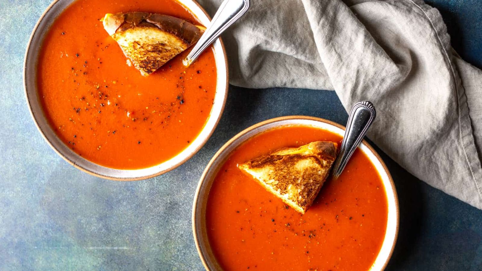 Spicy tomato soup with bread on the side.