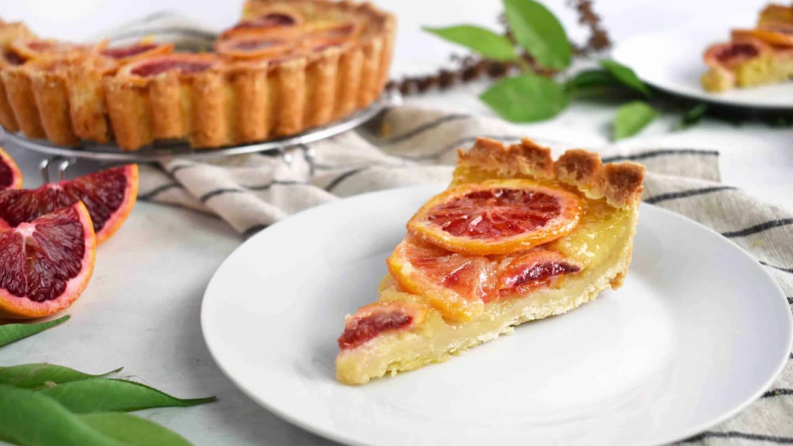 A slice of blood orange shaker tart on a plate.