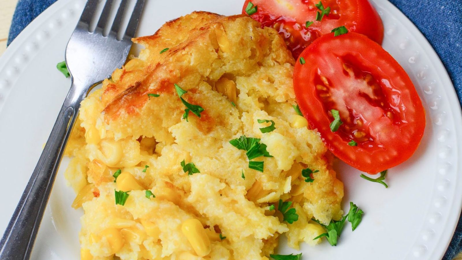 Corn casserole with sliced tomatoes.