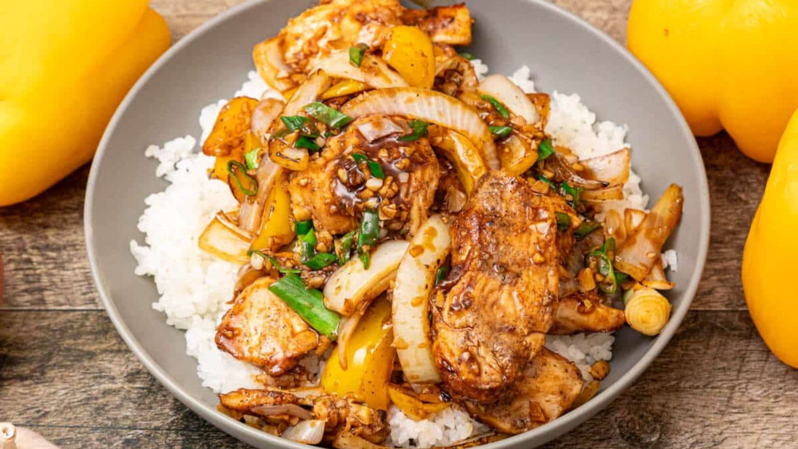 Black pepper chicken on top of rice.