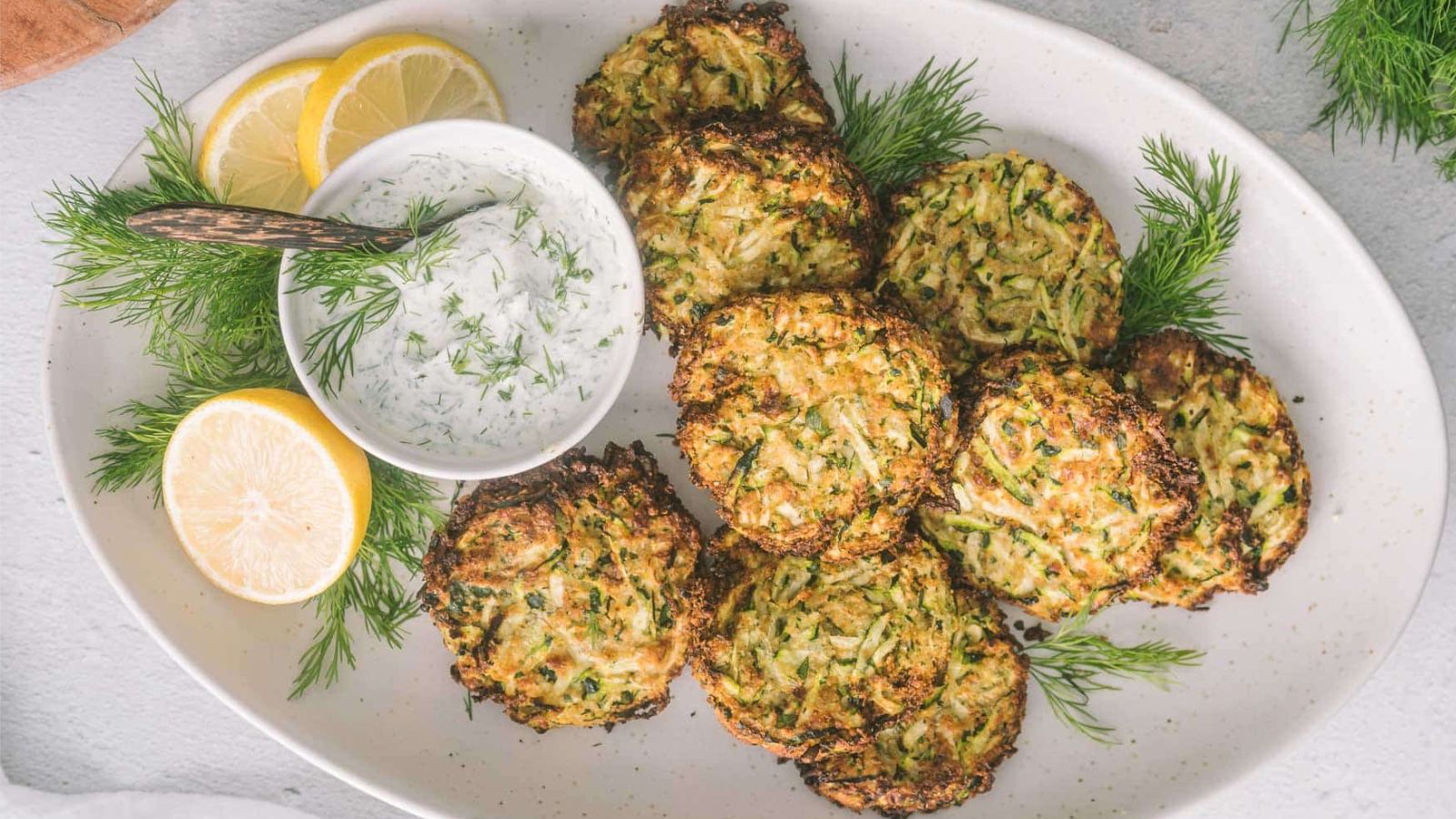Air fried zucchini fritters on a plate.