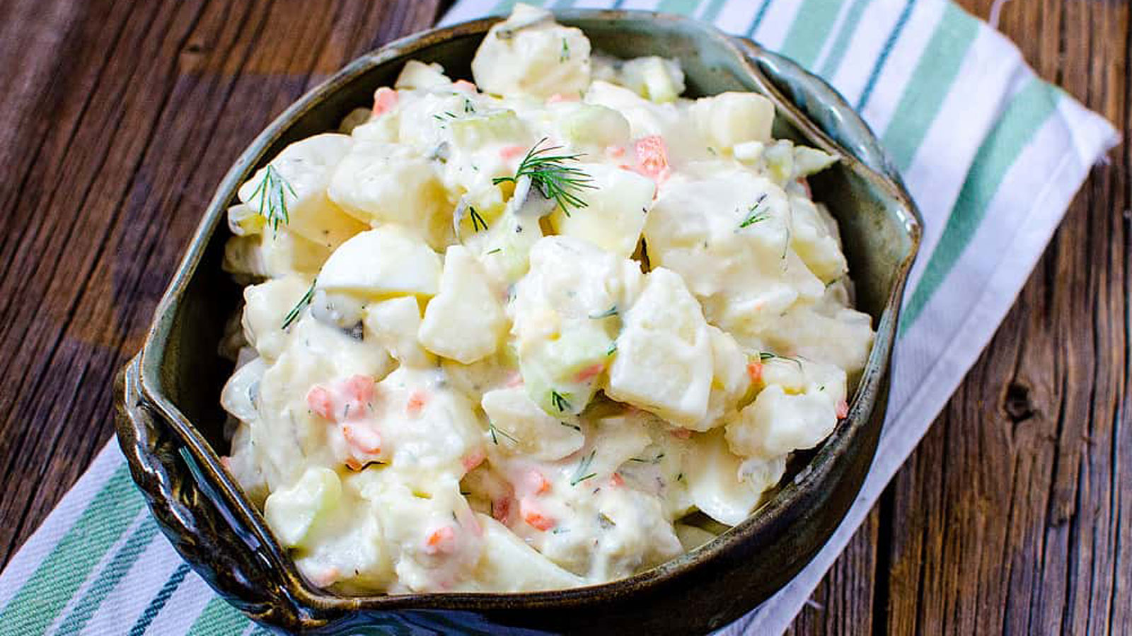 Dark bowl filled with potato salad.