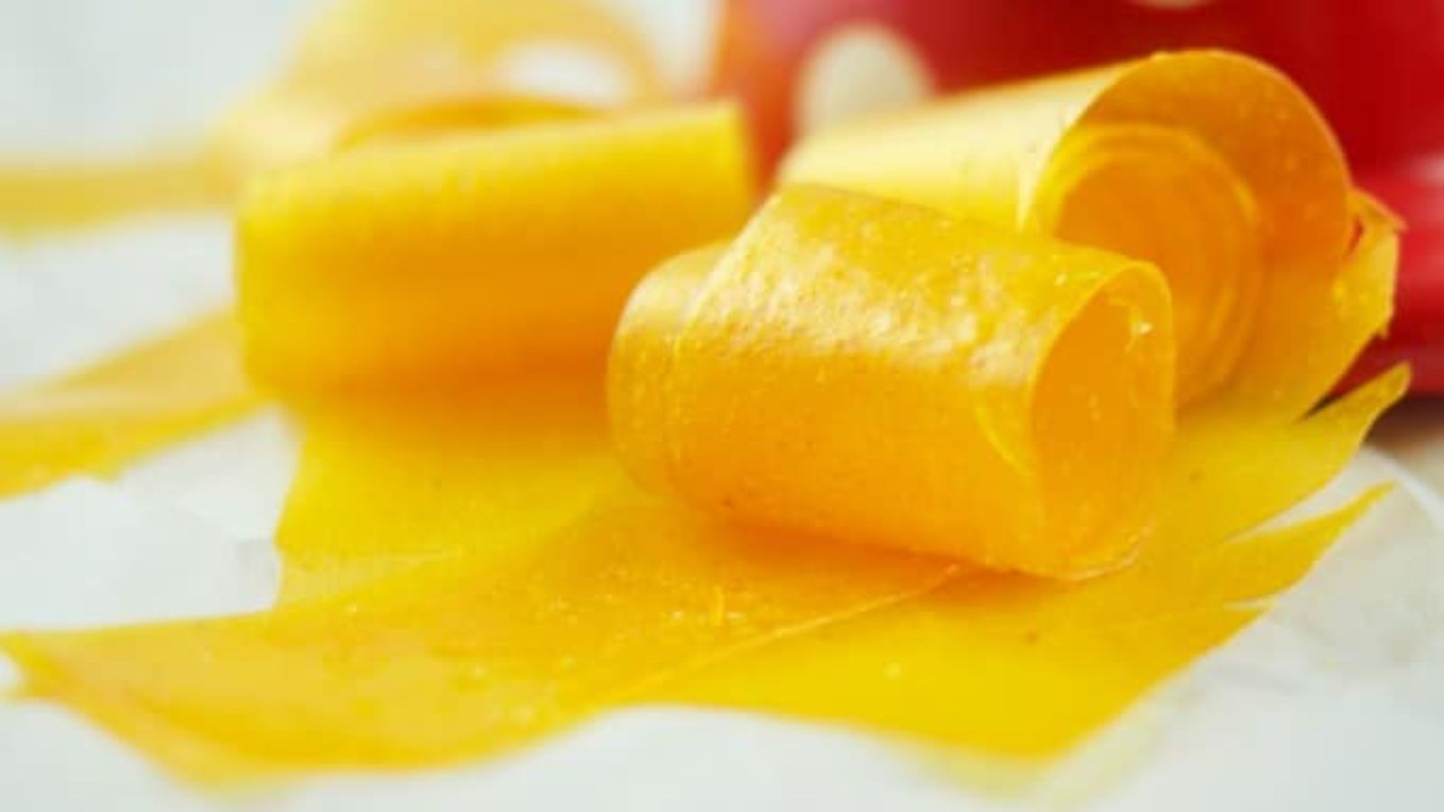 Mango fruit roll up on a white background.