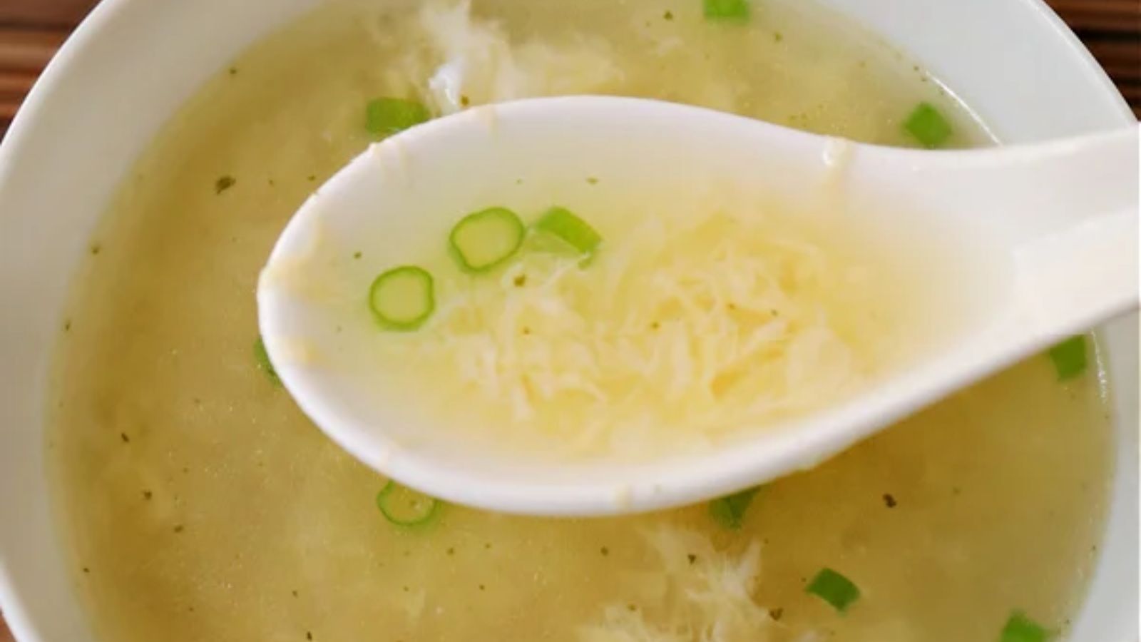 A spoon of egg drop soup.