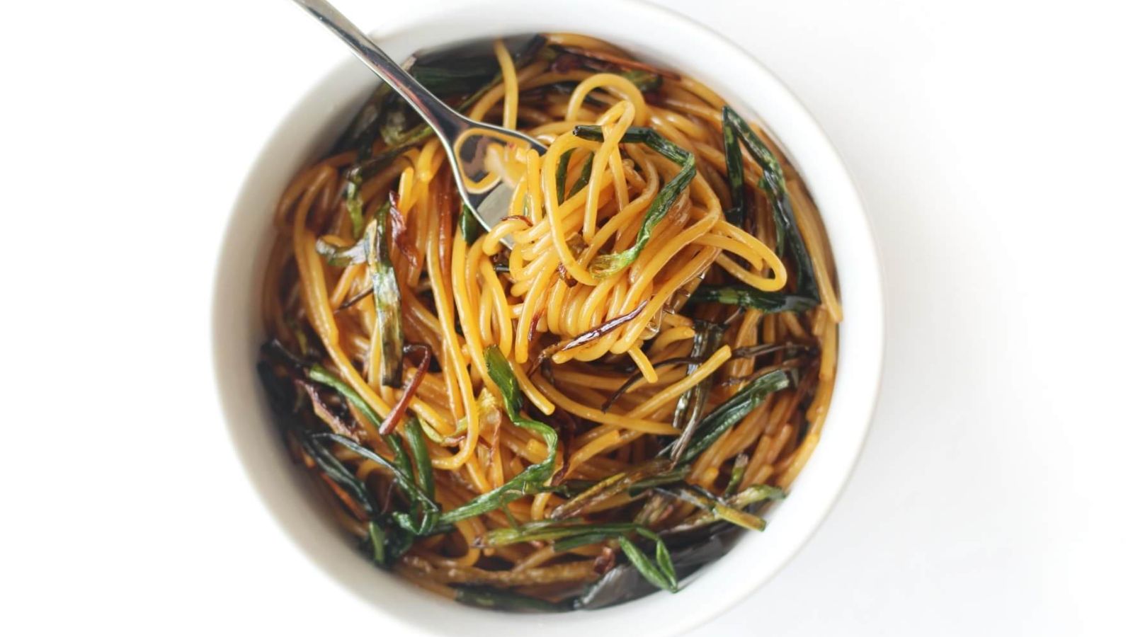 Scallion noodles in a bowl.