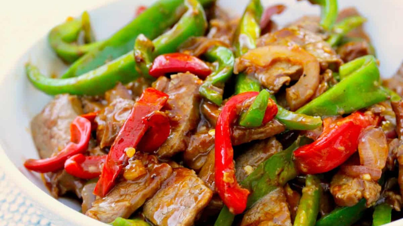 Beef with chopped peppers on top.