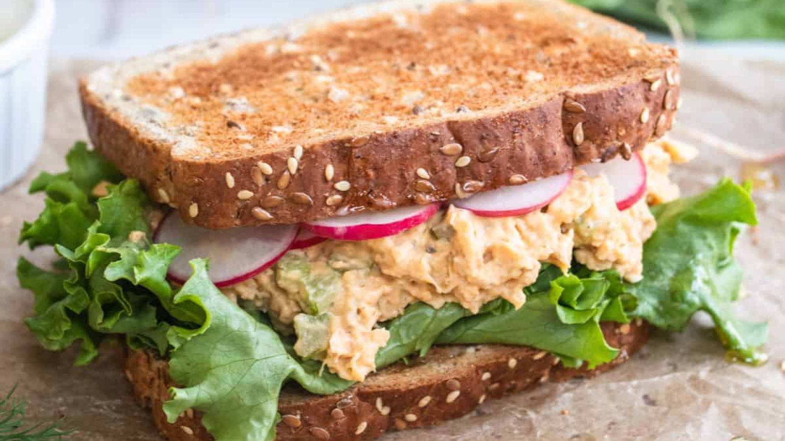 Chickpea sandwich on a wooden board.