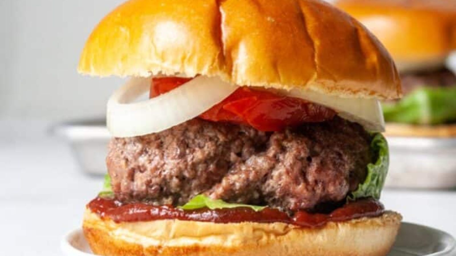 Juicy elk burgers on a plate.