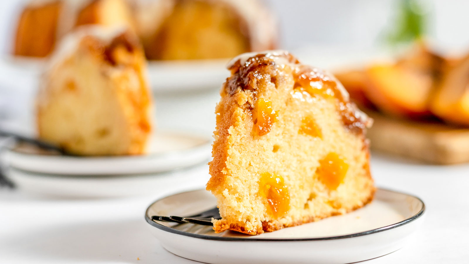 Pieces of peach pound cake on plates.
