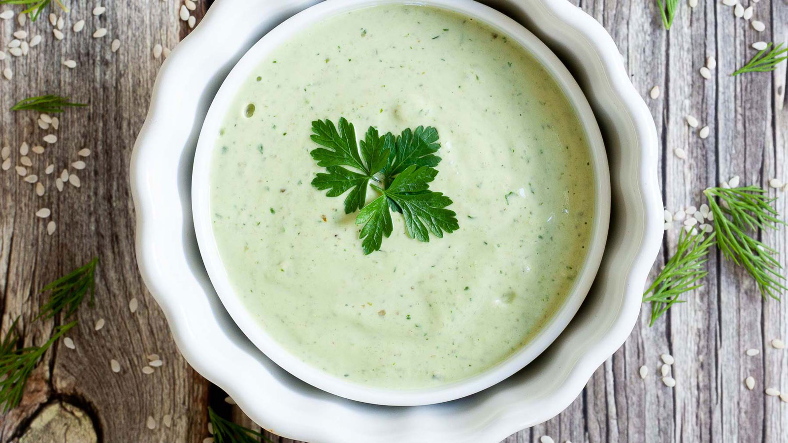 Green dressing in a white bowl.