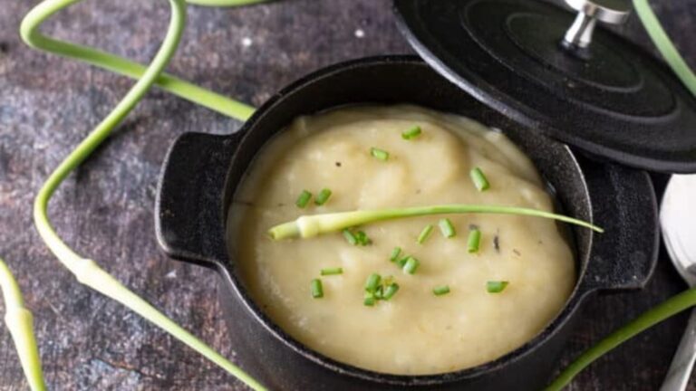 Cast iron Dutch oven with garlic scape soup.