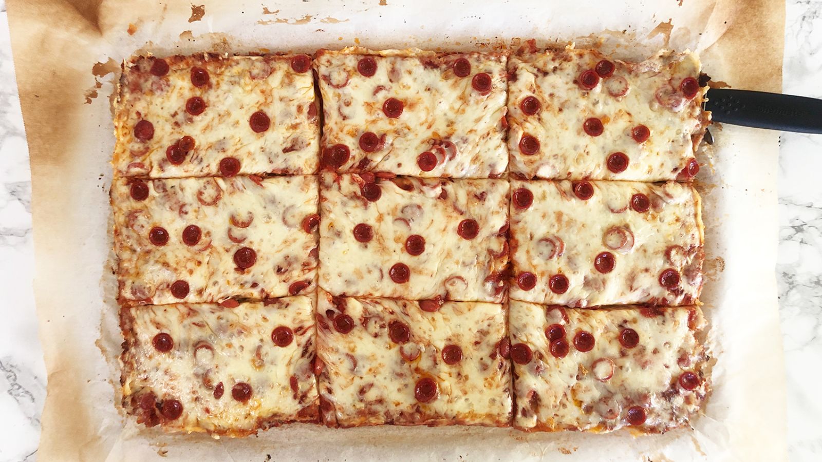 Pizza slices on a parchment paper.