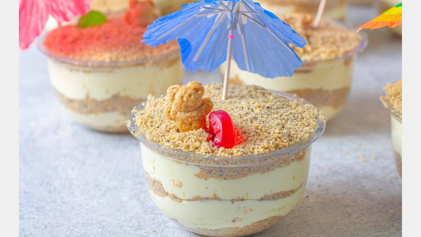 Layered Sand Cups with a blue umbrella.