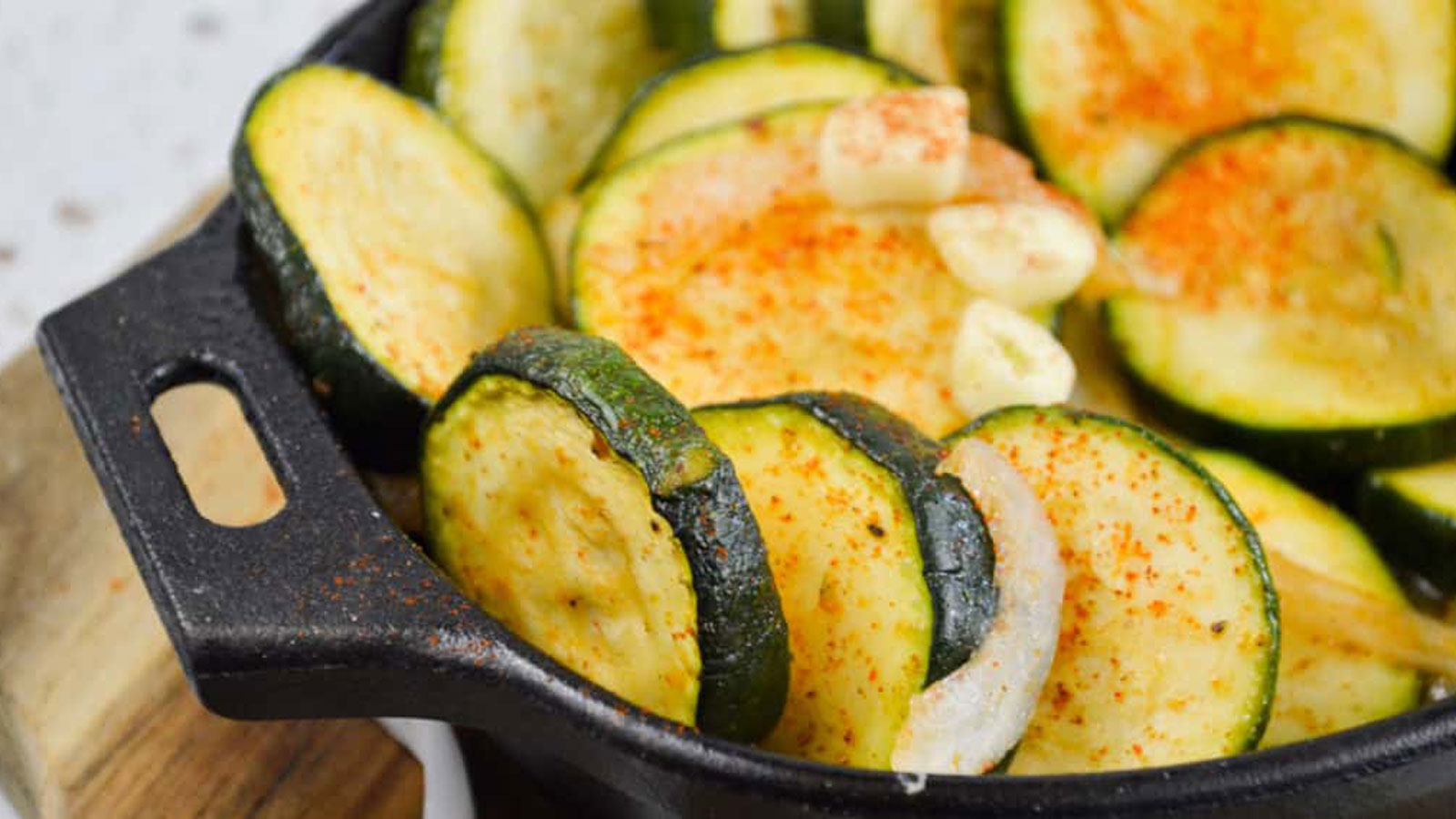 Zucchini and onions in a cast iron Dutch oven.