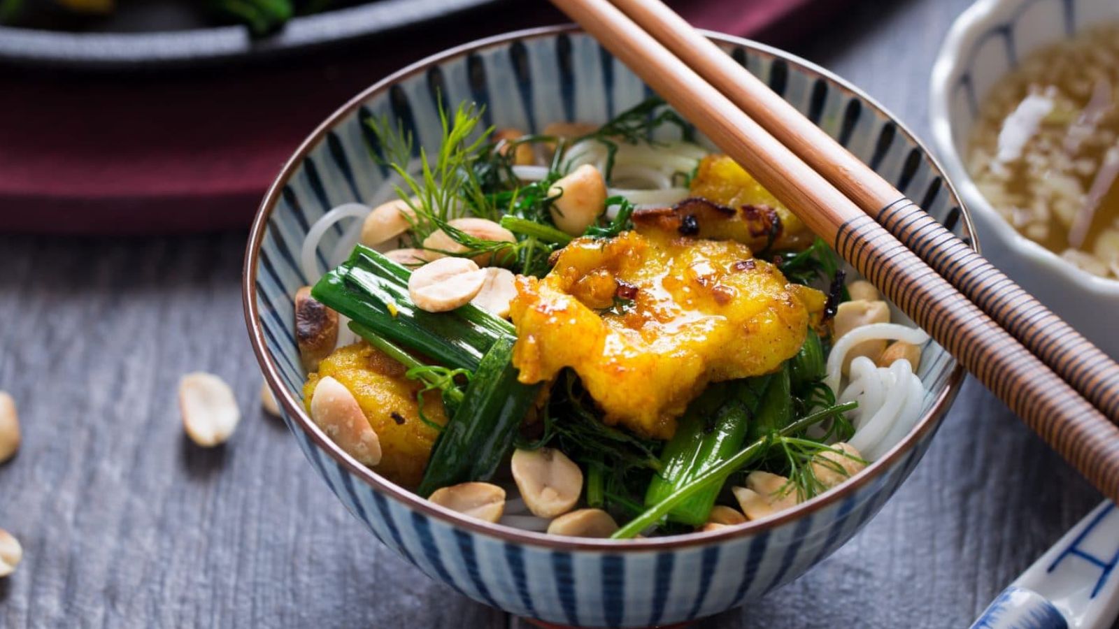 Fish with dill and noodles in a bowl.