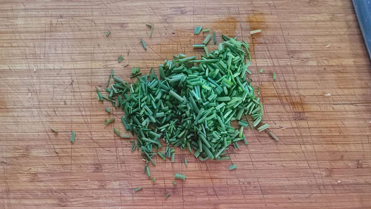 Chopped herbs on a board.