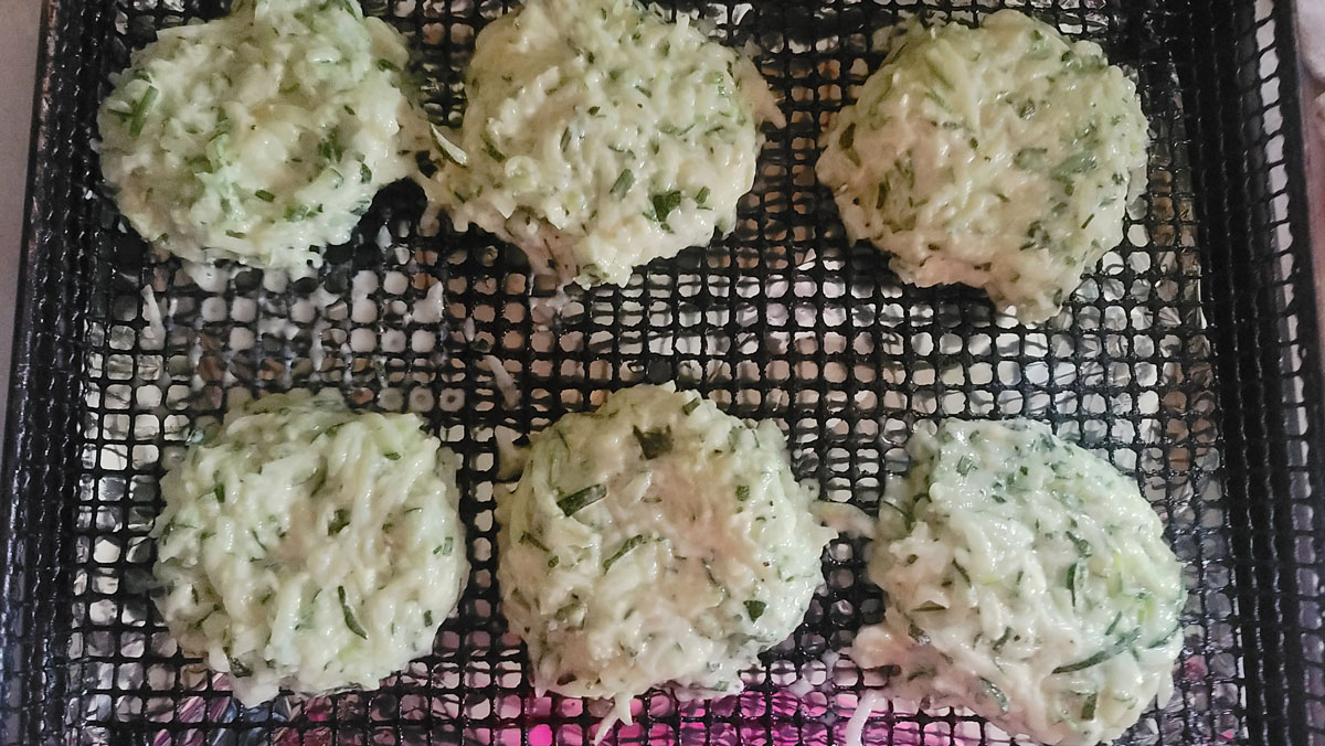 Patties on the air fryer basket.