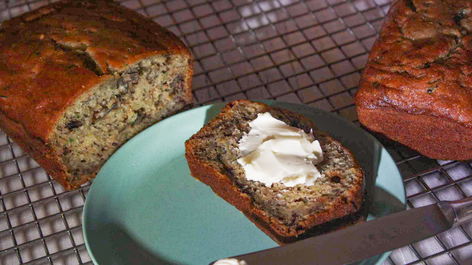 Slice of Zucchini bread slathered with soft butter.