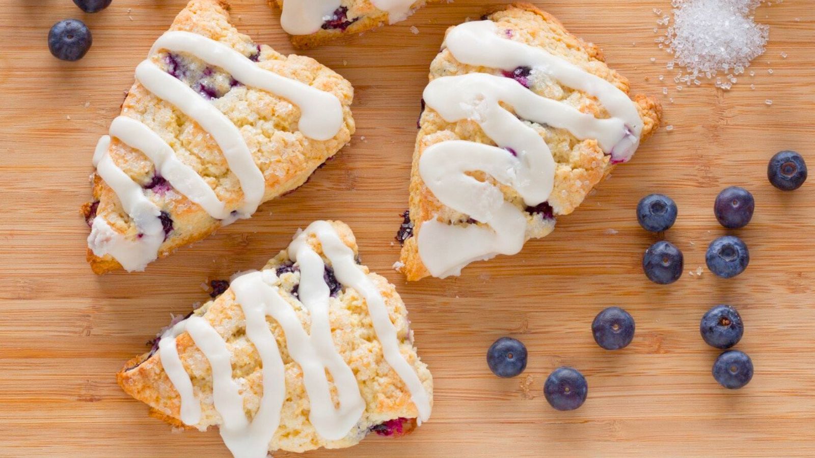 blueberry scones on a wooden cutting board.