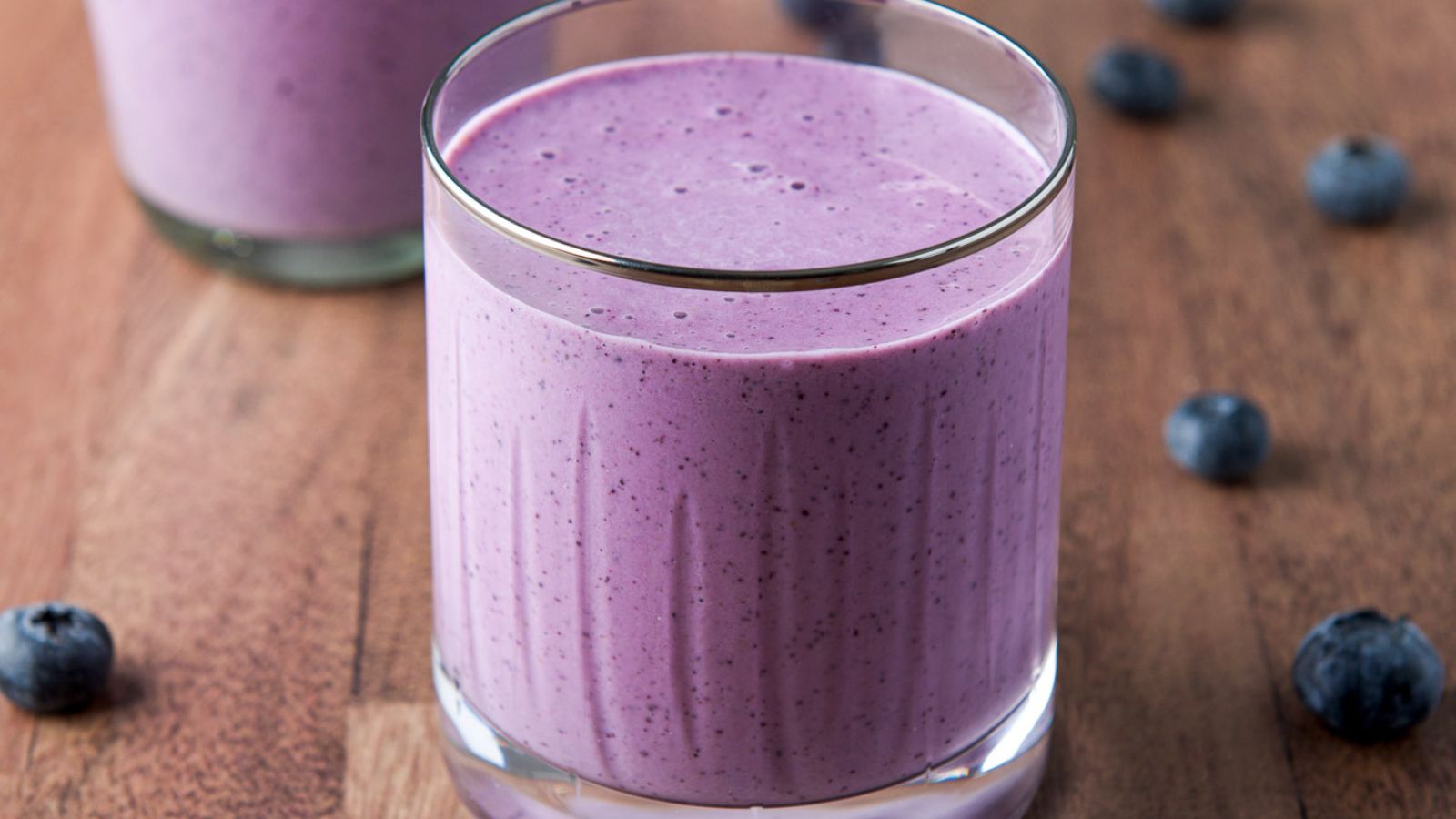 Close up of a glass of blueberry smoothie.