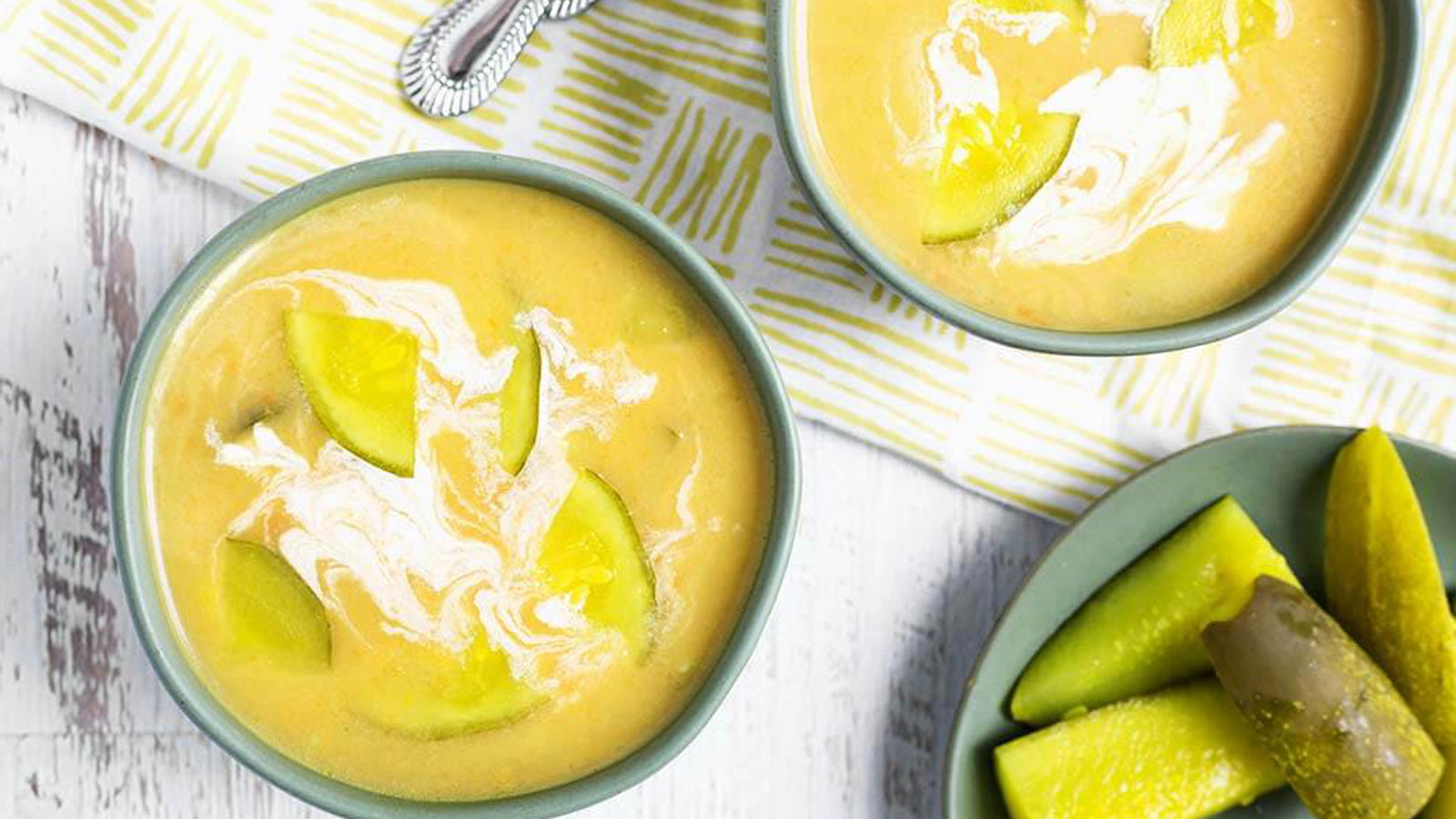 Two bowls filled with pickle soup.