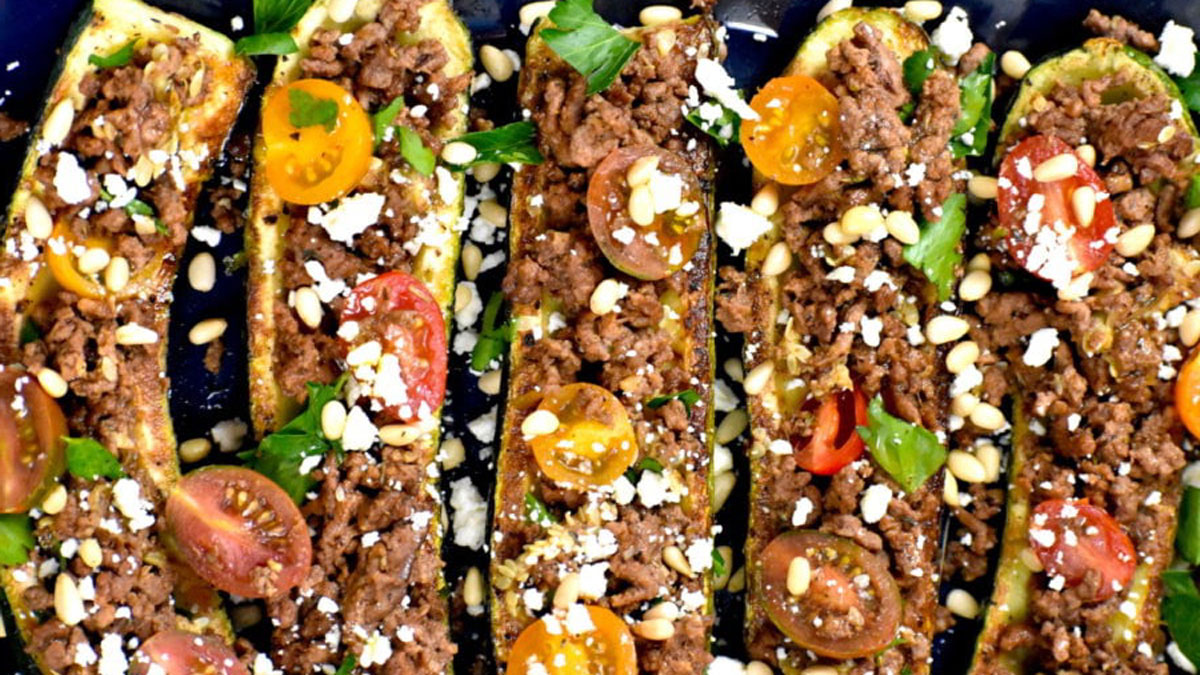 Zucchini boats stuffed with meat, cheese, and tomatoes.