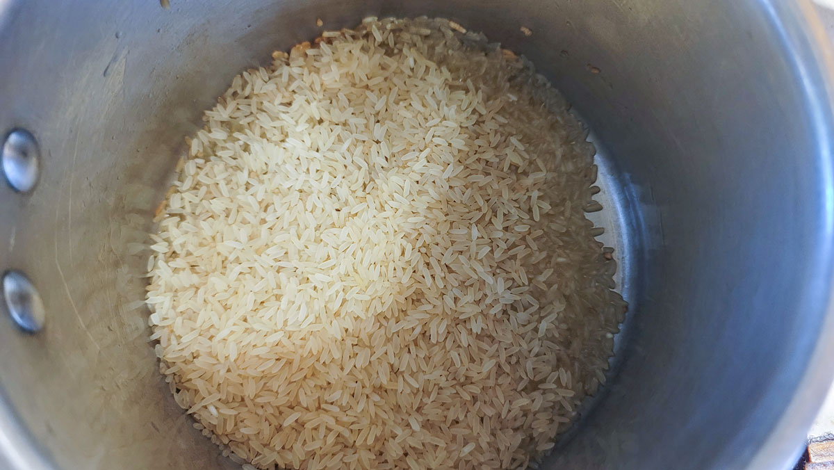 Toasting rice in a saucepan.