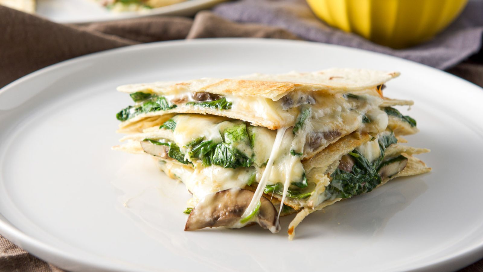 Mushroom and spinach quesadillas on a plate.