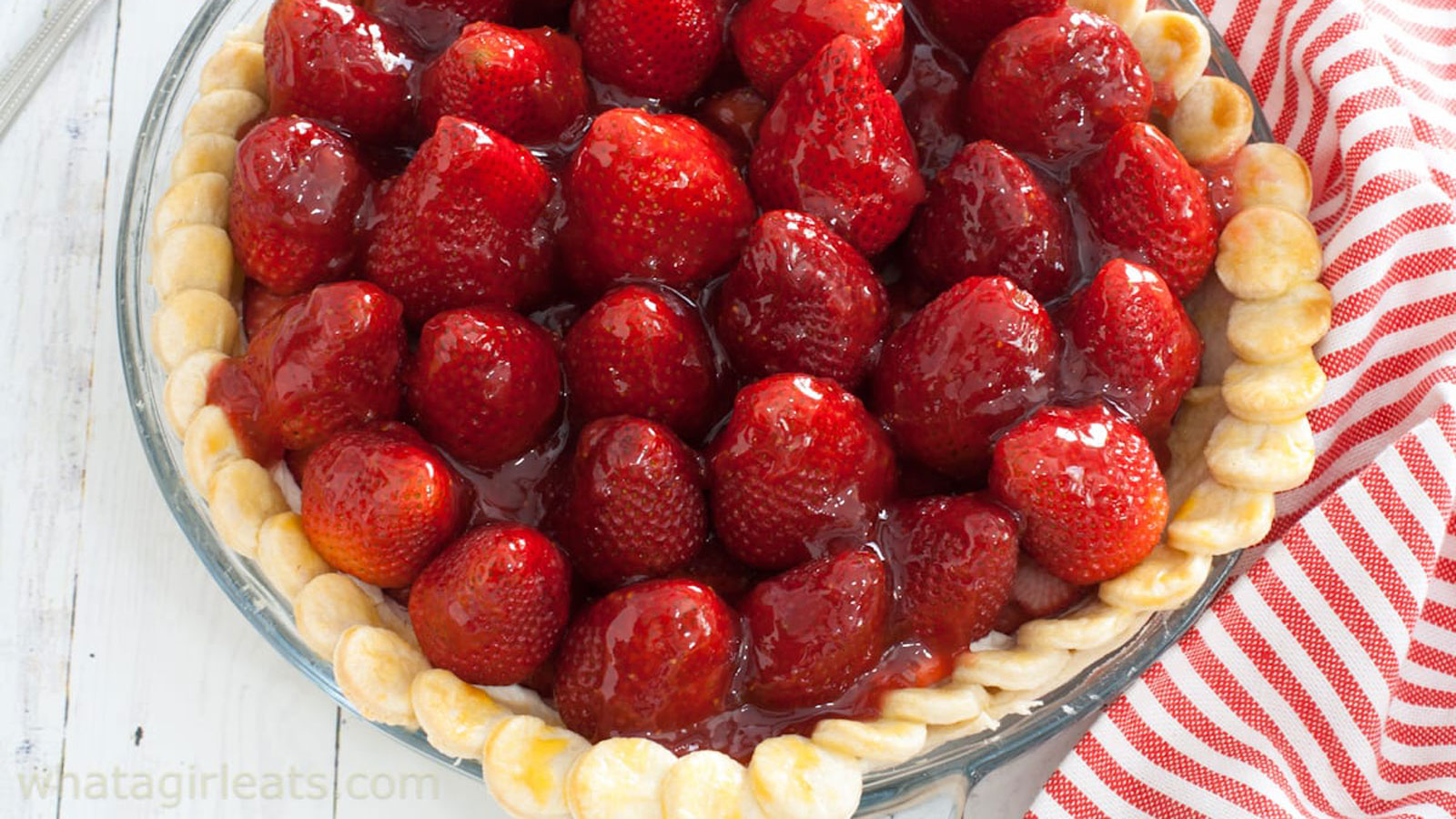 Pie filled with whole upside down strawberries topped with a glaze.