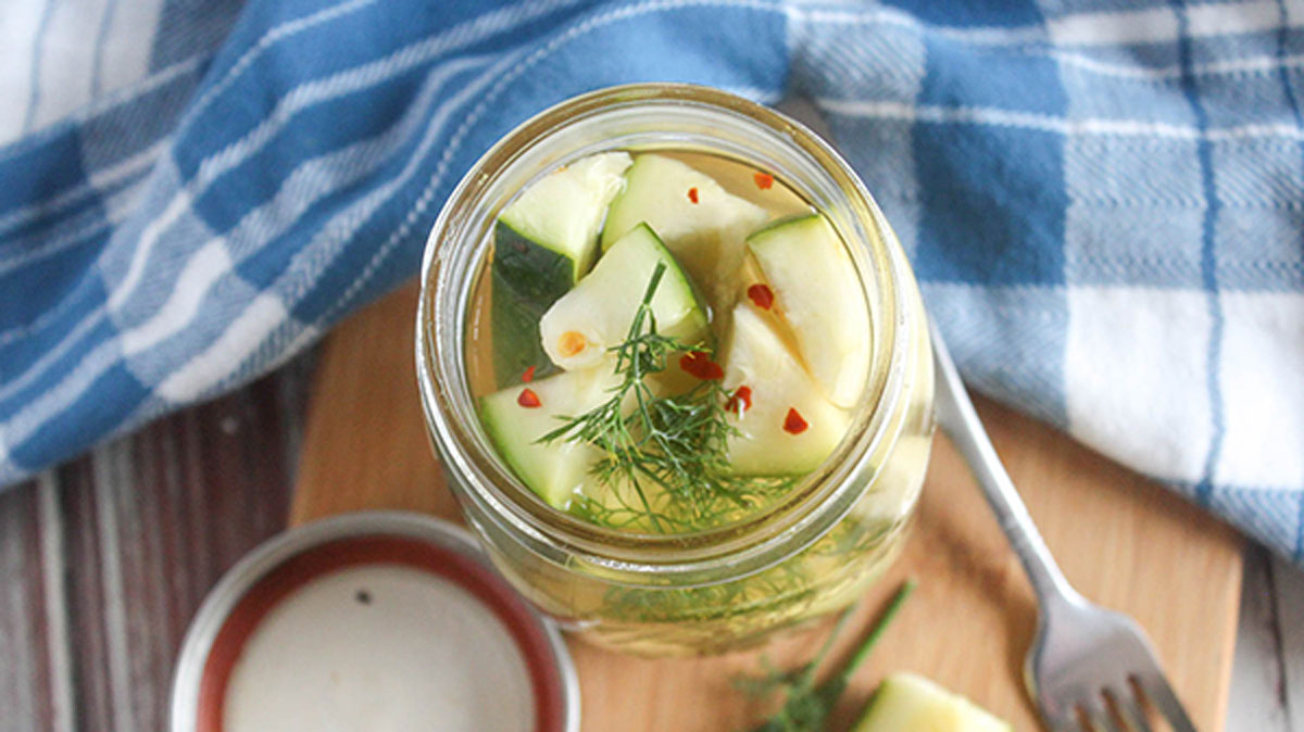 Over photo of an open bottle of zucchini pickles.