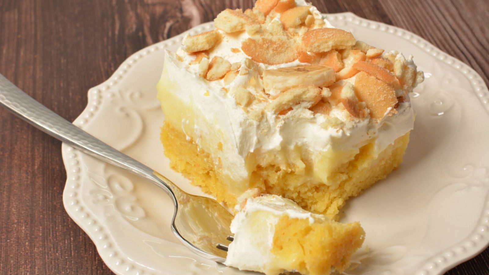 A slice of banana pudding poke cake.