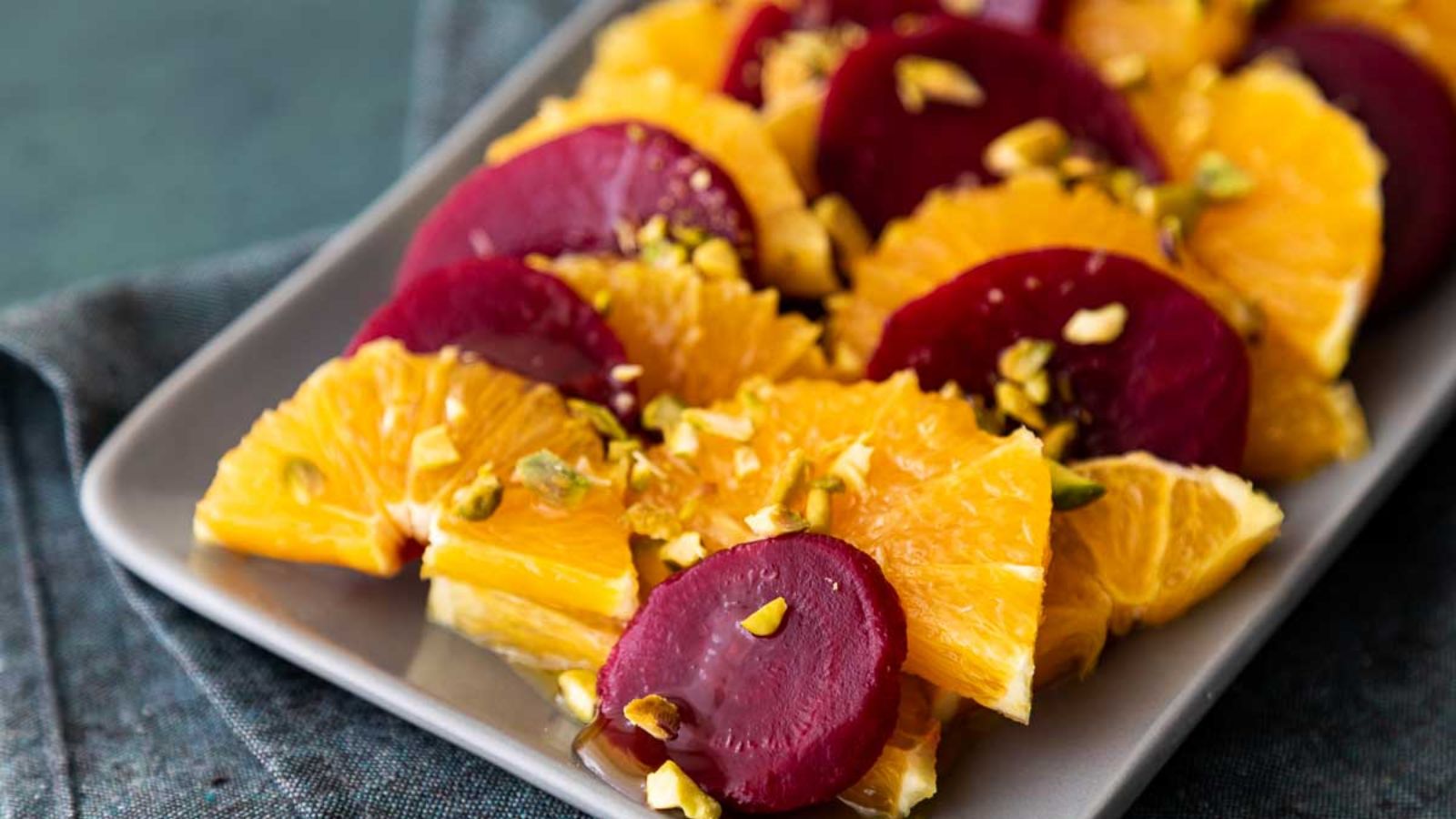 Beets with orange slices on a plate.