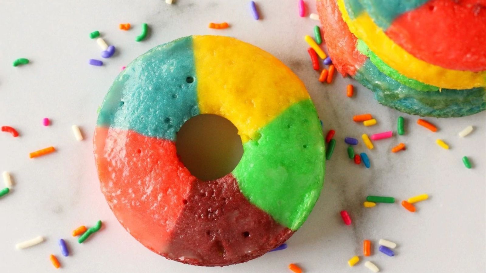 Rainbow donuts with sprinkles.