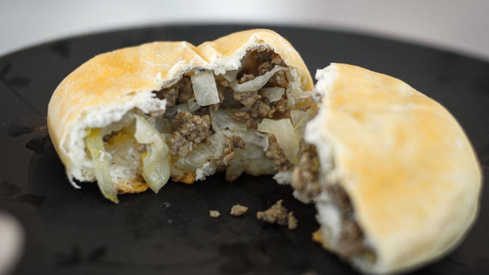 Bread cut in to two with beef and cabbage.