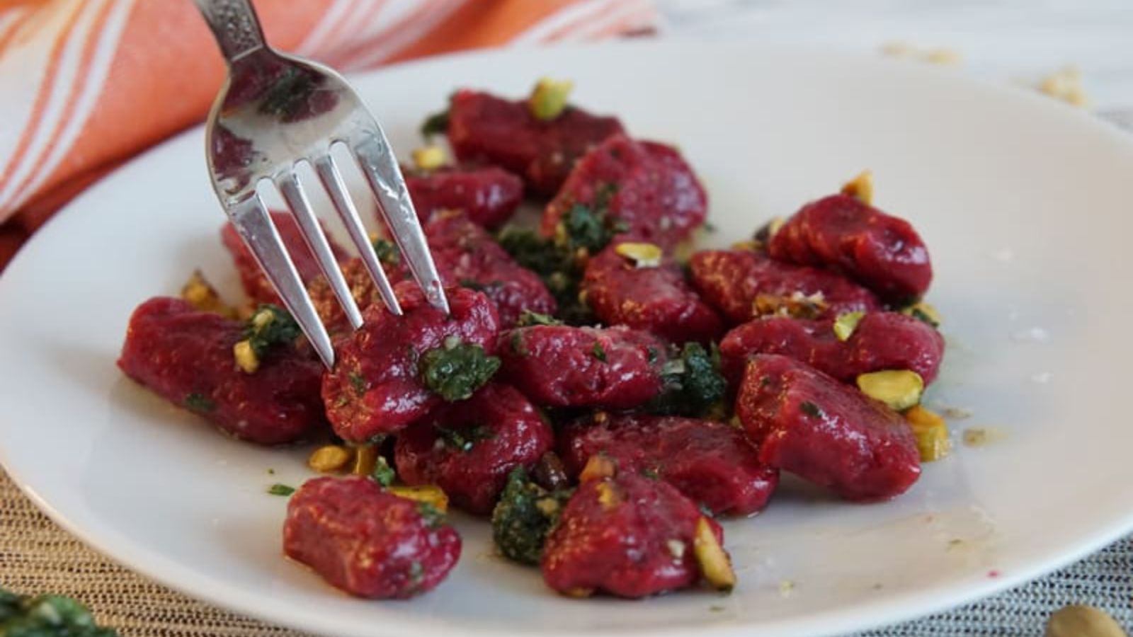 Homemade beet gnocchi on a plate.