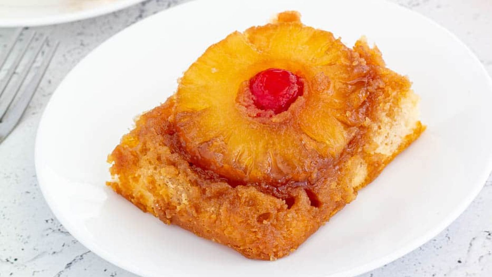 Pineapple upside down cake with cherry on top.
