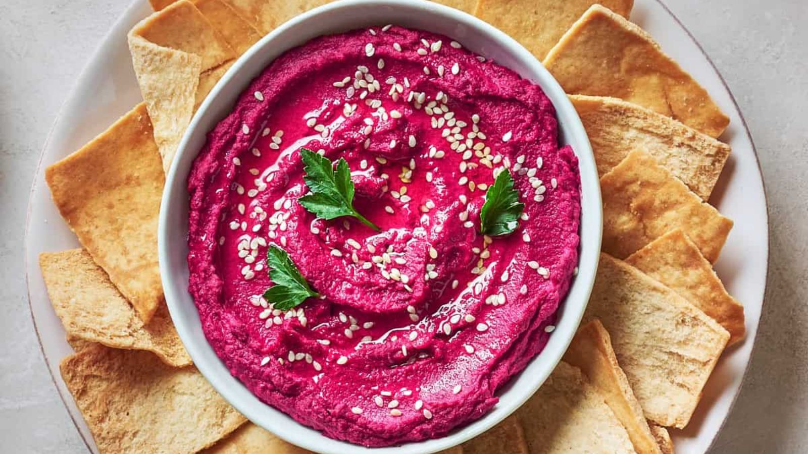Roasted beet hummus in a bowl.
