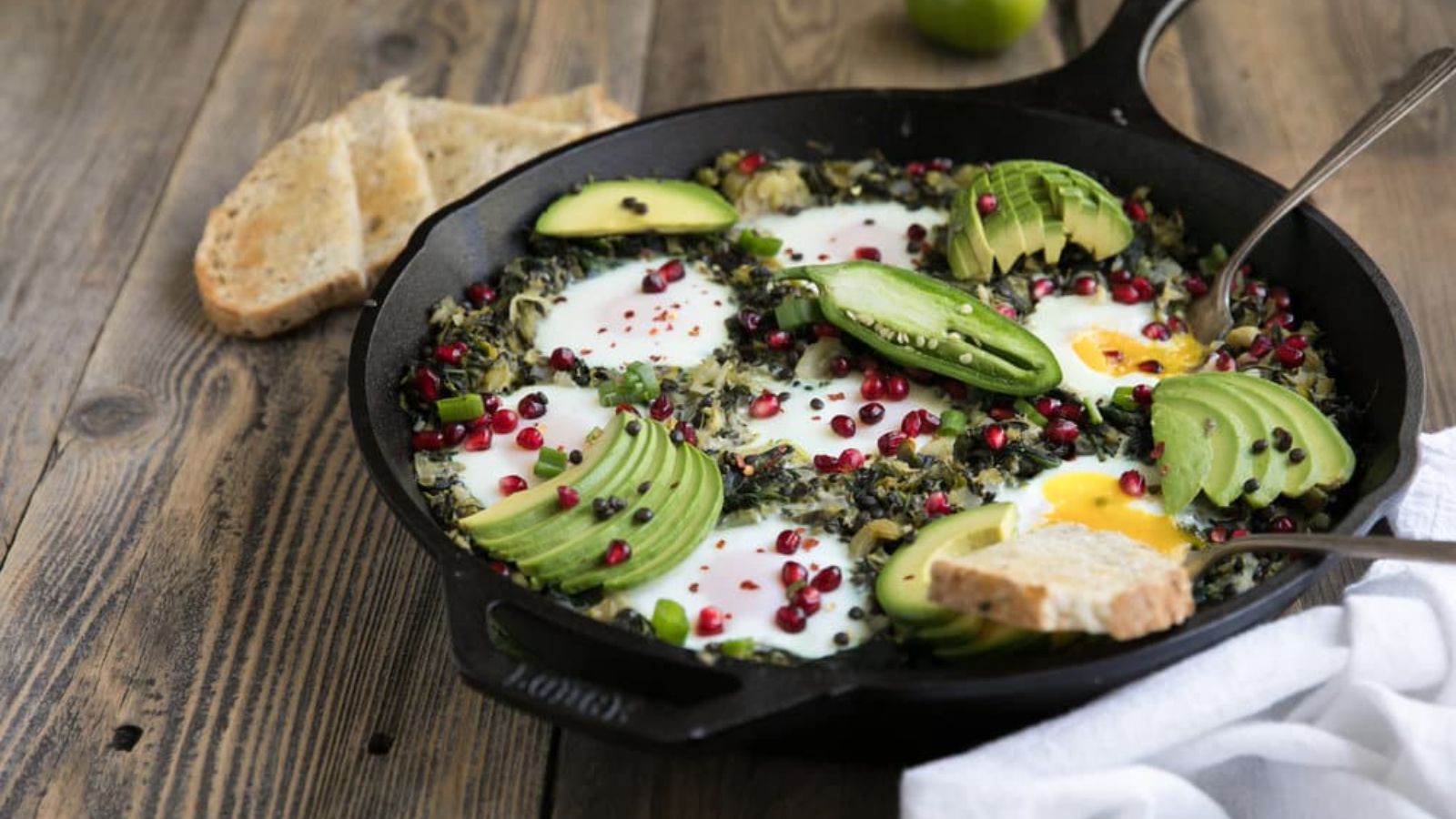 Green shakshuka in a pan.