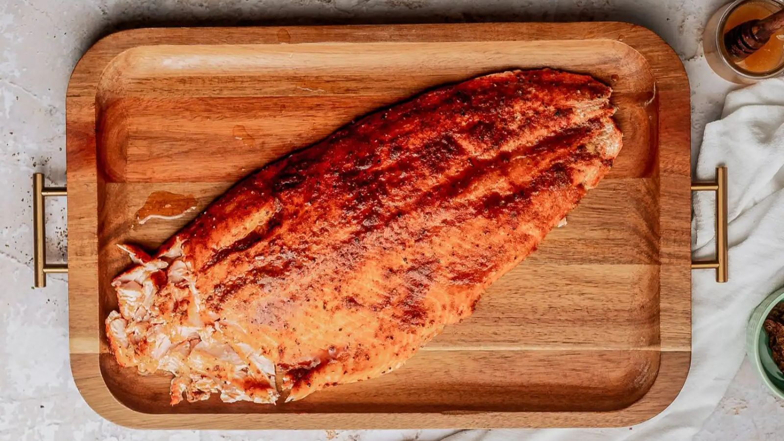 Honey chipotle salmon on a wooden board.