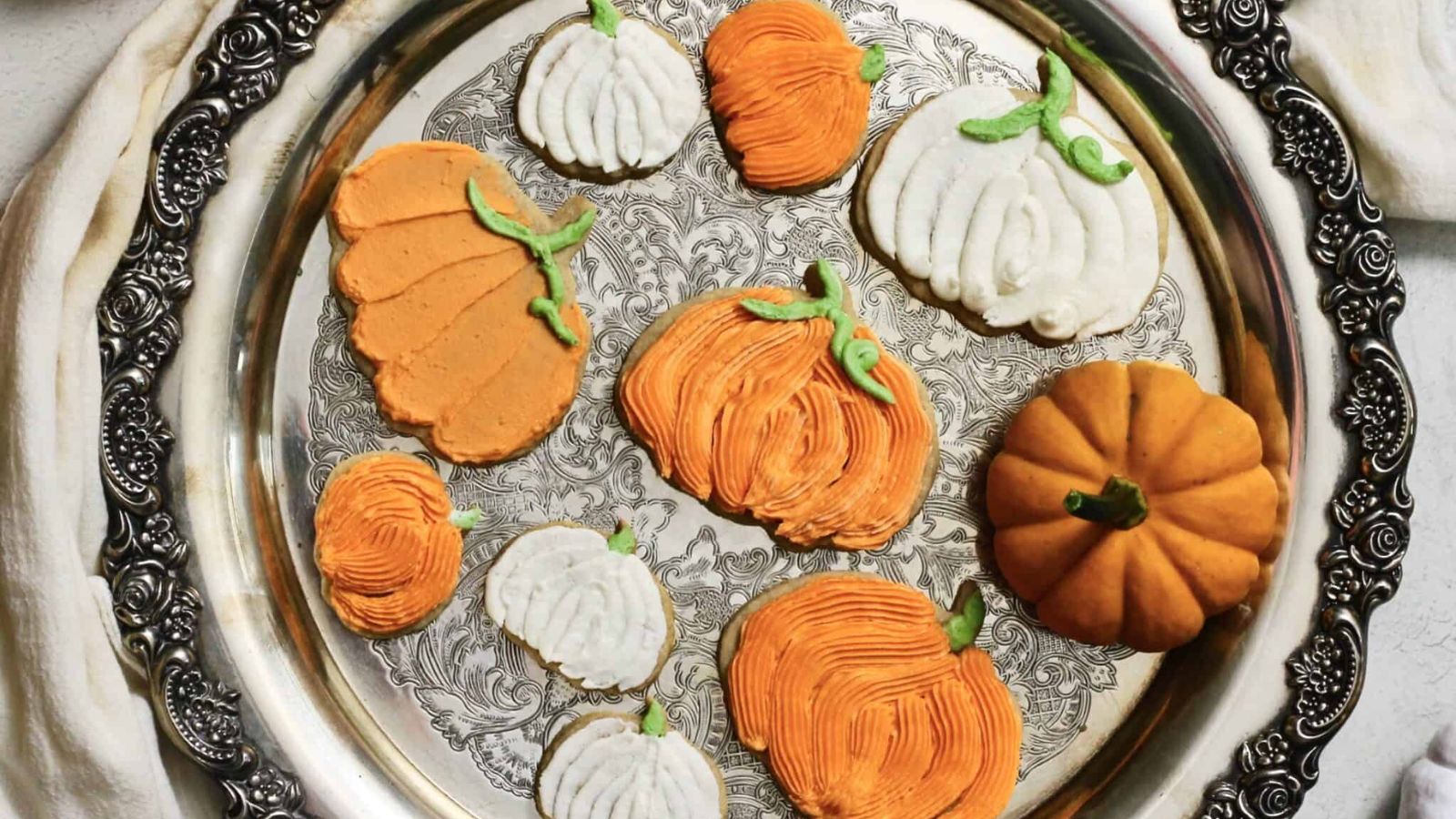 Pumpkin sugar cookies on a plate.