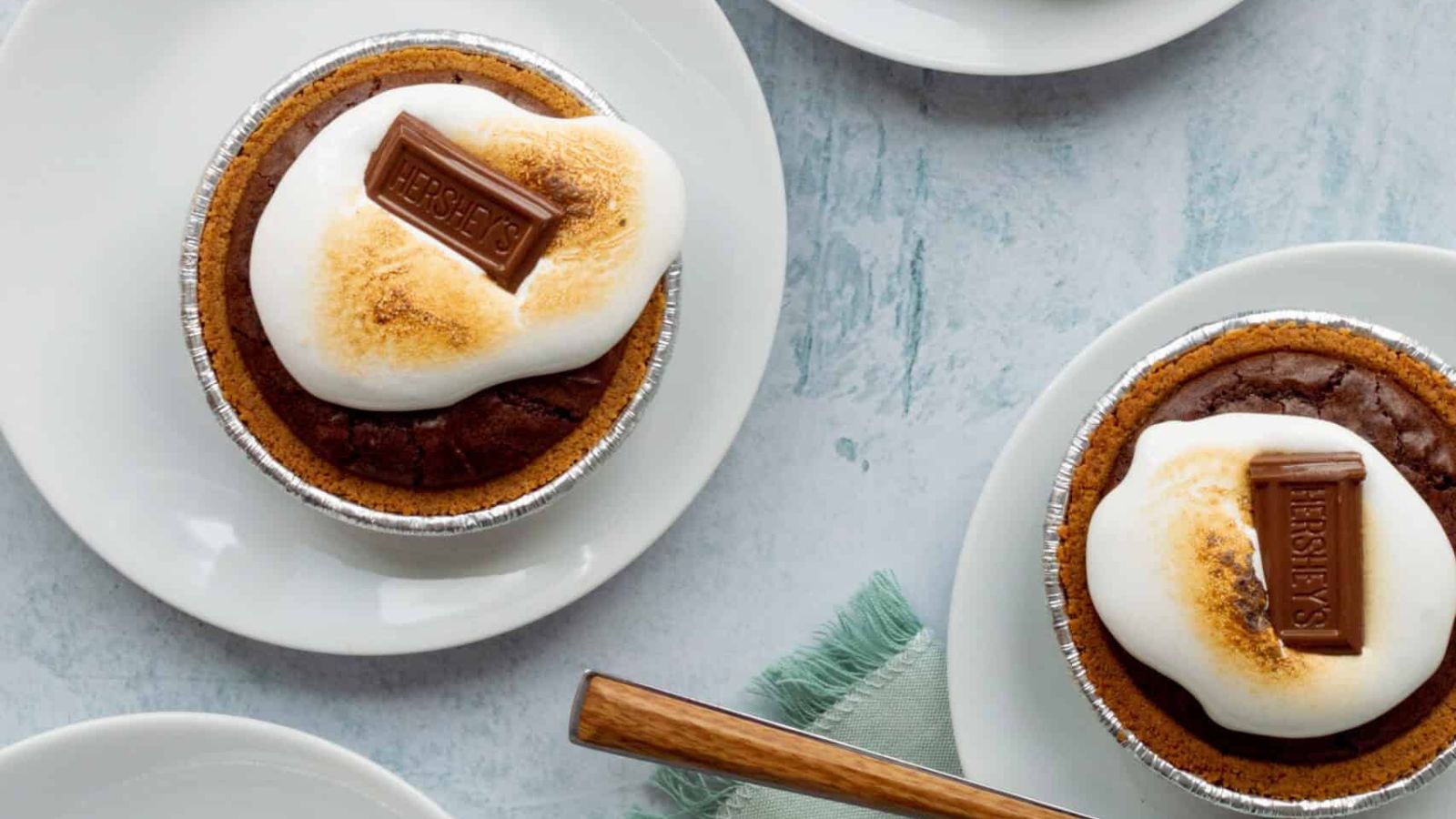 Mini s'mores pies with chocolate on top.