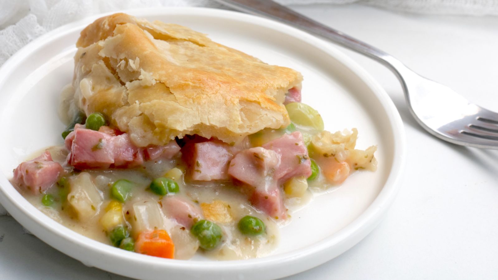 Ham pot pie on a plate.