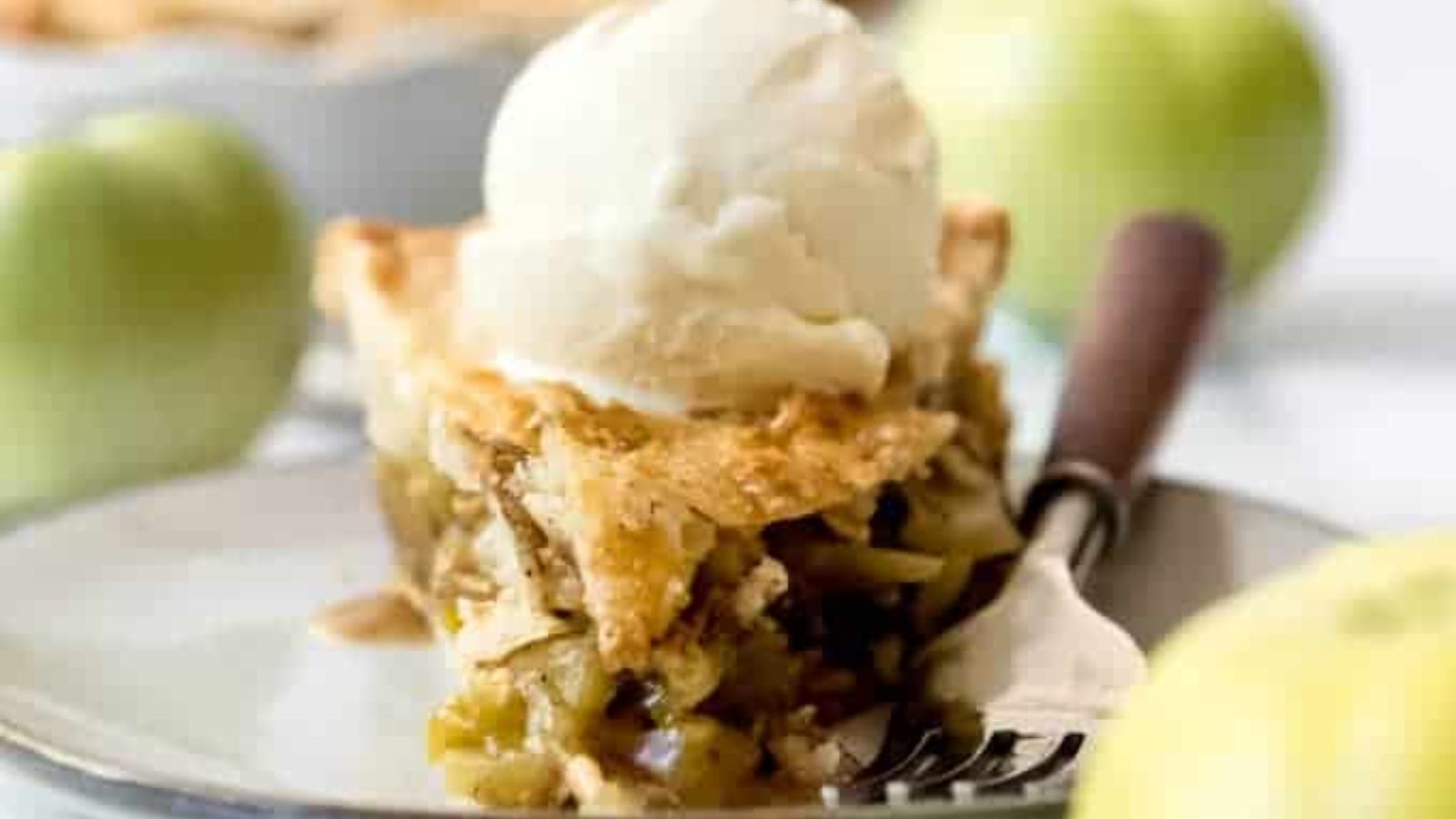 Green apple tomato pie with a scoop of ice cream on top.