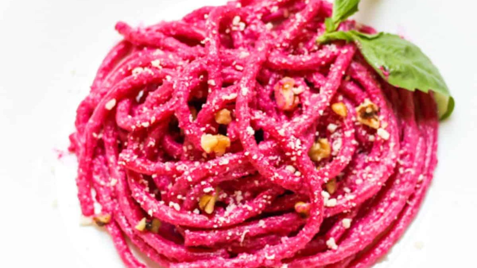 Pasta with beet sauce on a plate.