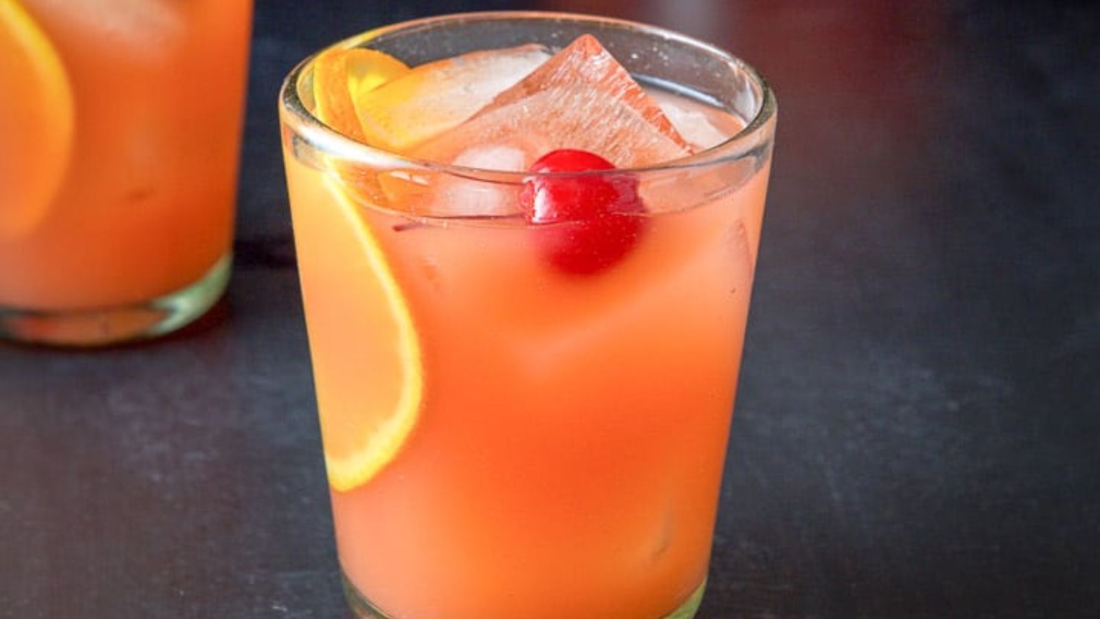 Scorpion bowl cocktail with cherry and sliced orange.