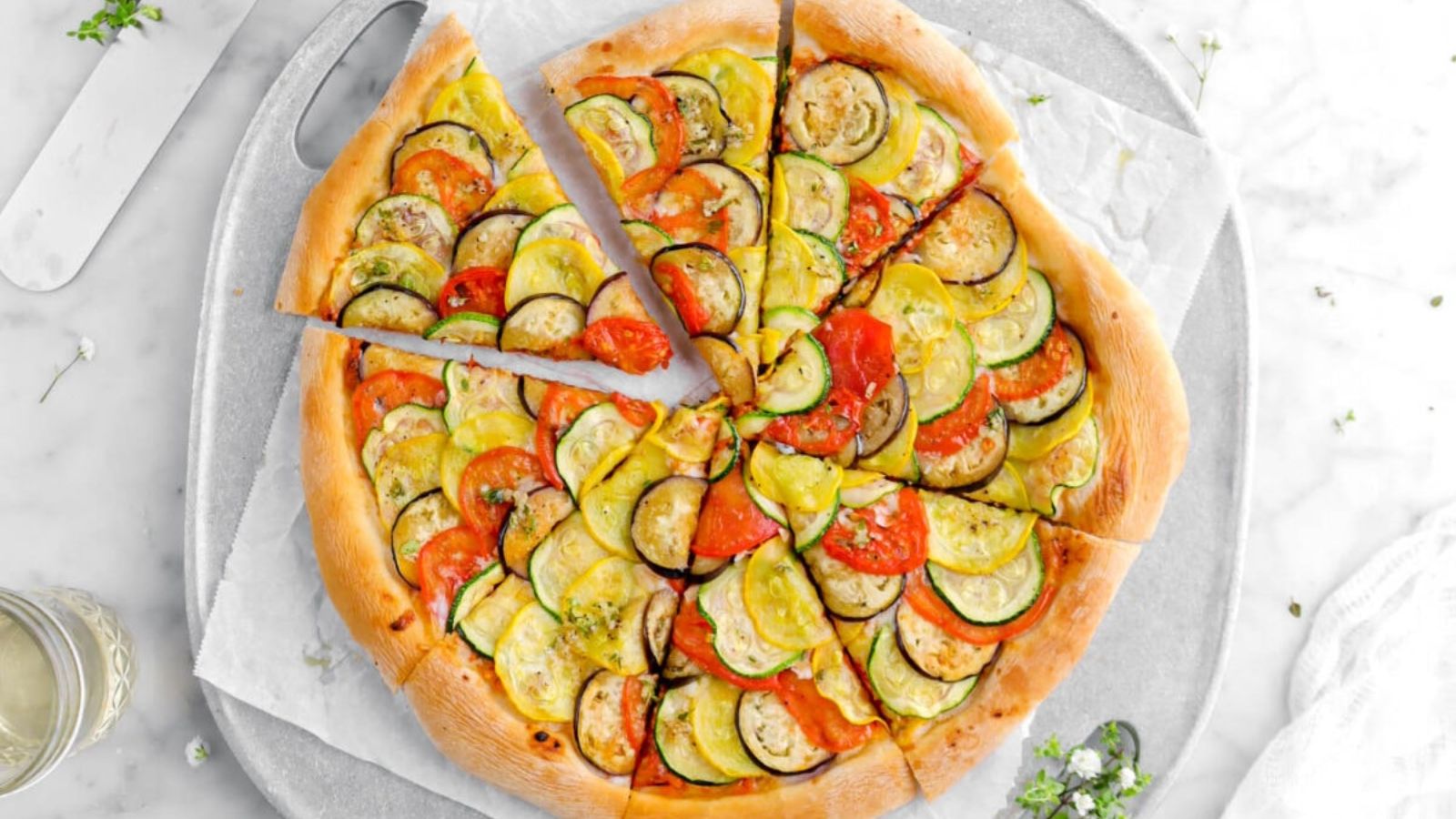 Sliced pizza with zucchini on top.